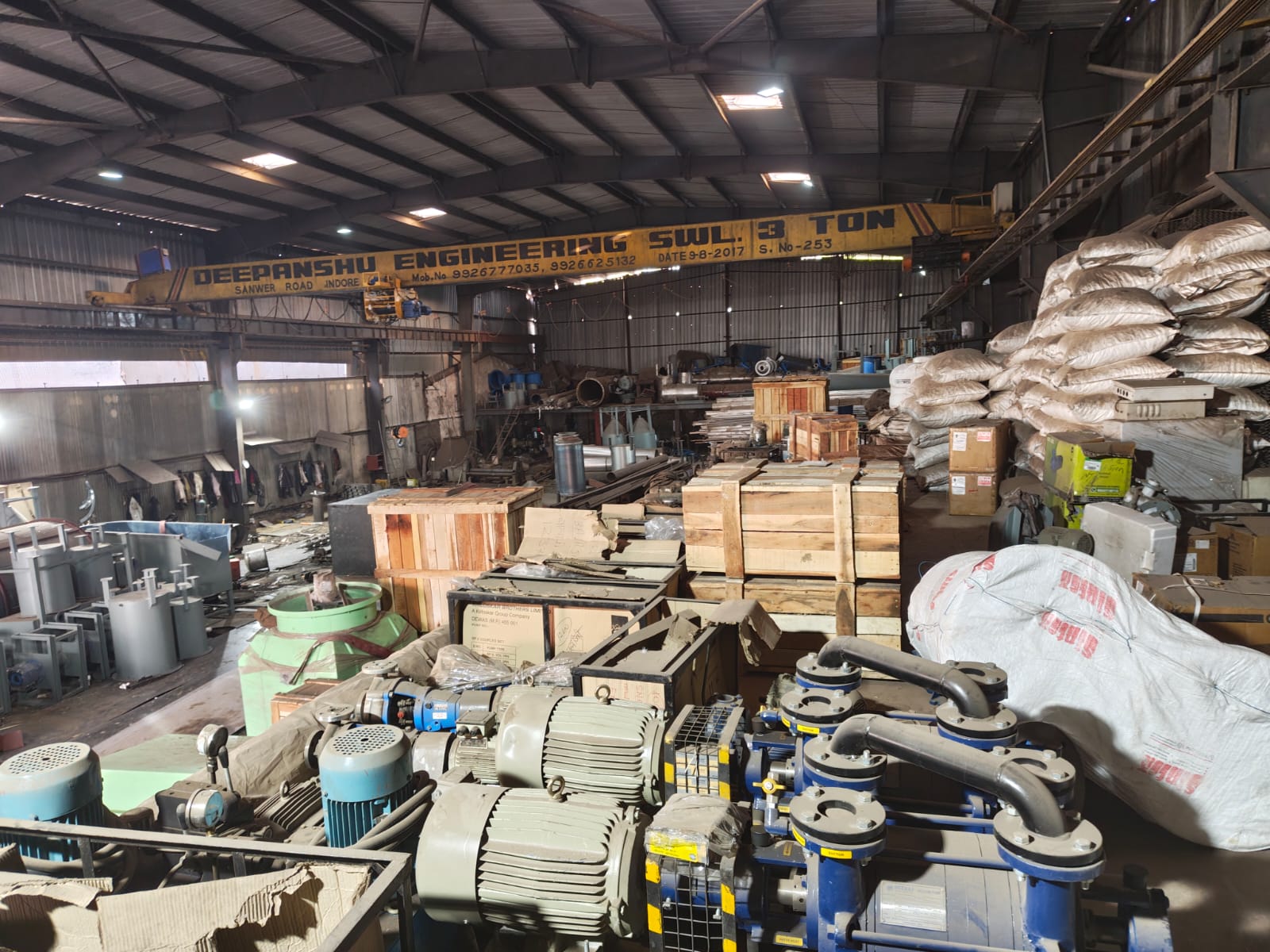 Heavy-duty industrial manufacturing workshop with overhead crane and equipment by Distington Engineers & Consultant Pvt. Ltd.